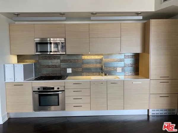 a kitchen with a stove microwave and cabinets
