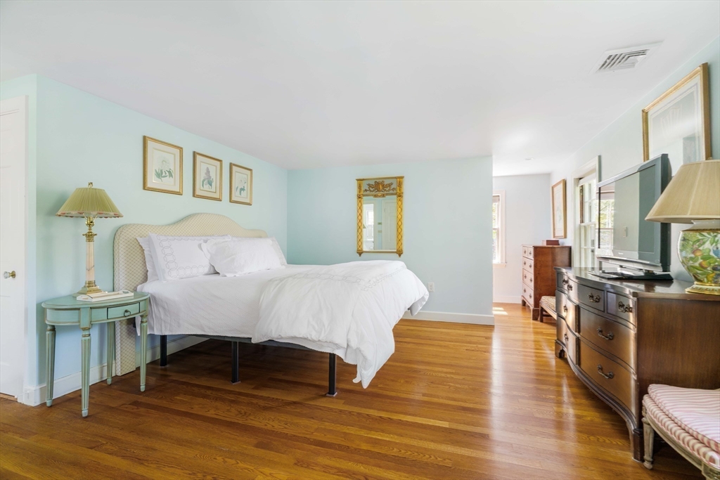 81 Hampshire Road Wellesley, MA 02481 - Photo 18 of 28 a spacious bedroom with a bed and wooden floor