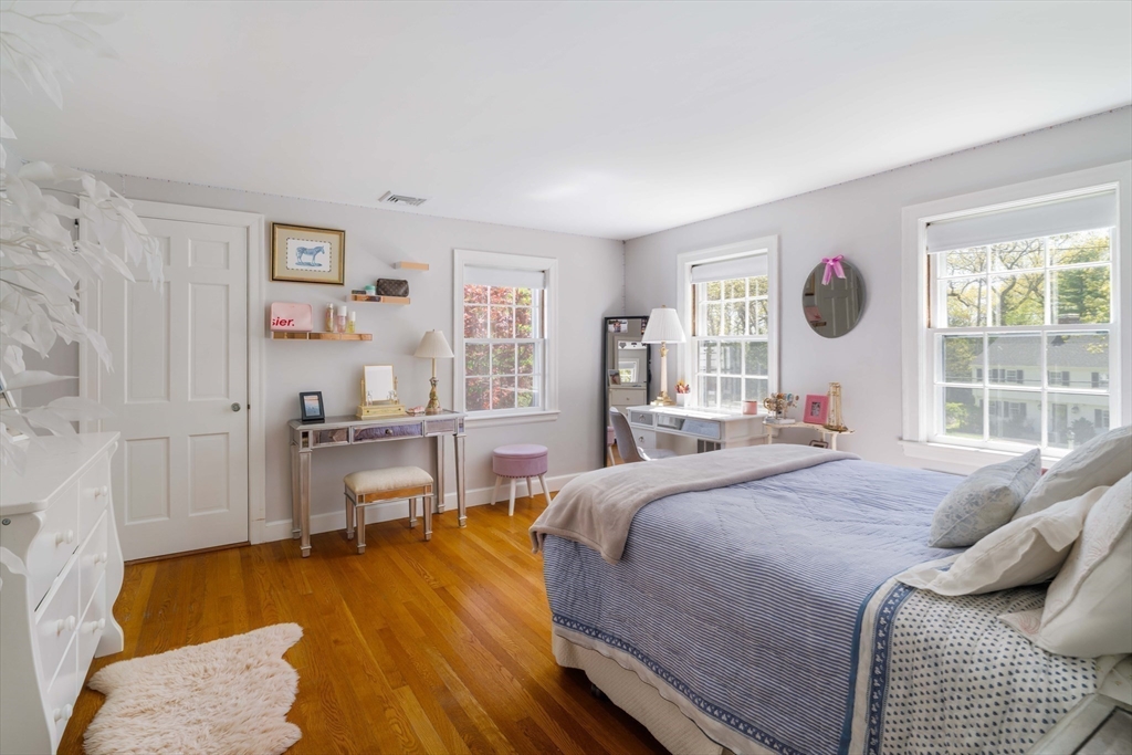 81 Hampshire Road Wellesley, MA 02481 - Photo 22 of 28 a bedroom with a bed and a table in it next to a window