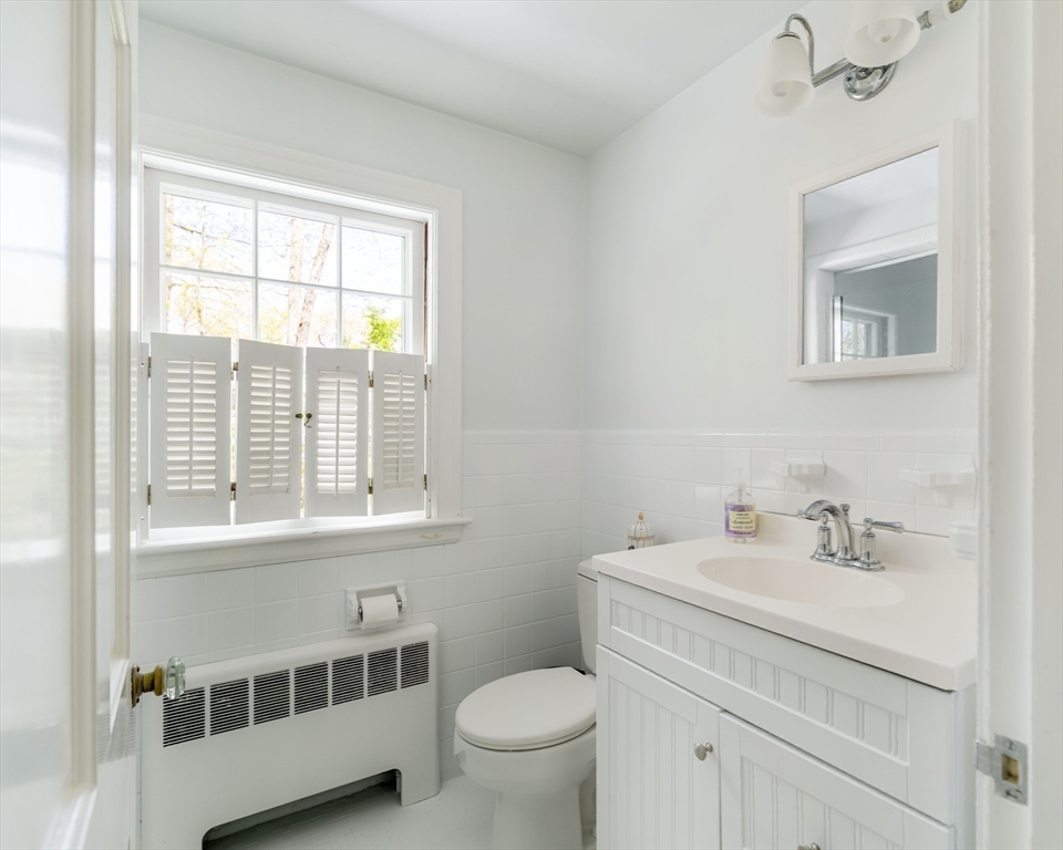 81 Hampshire Road Wellesley, MA 02481 - Photo 24 of 28 a bathroom with a toilet a sink and a window