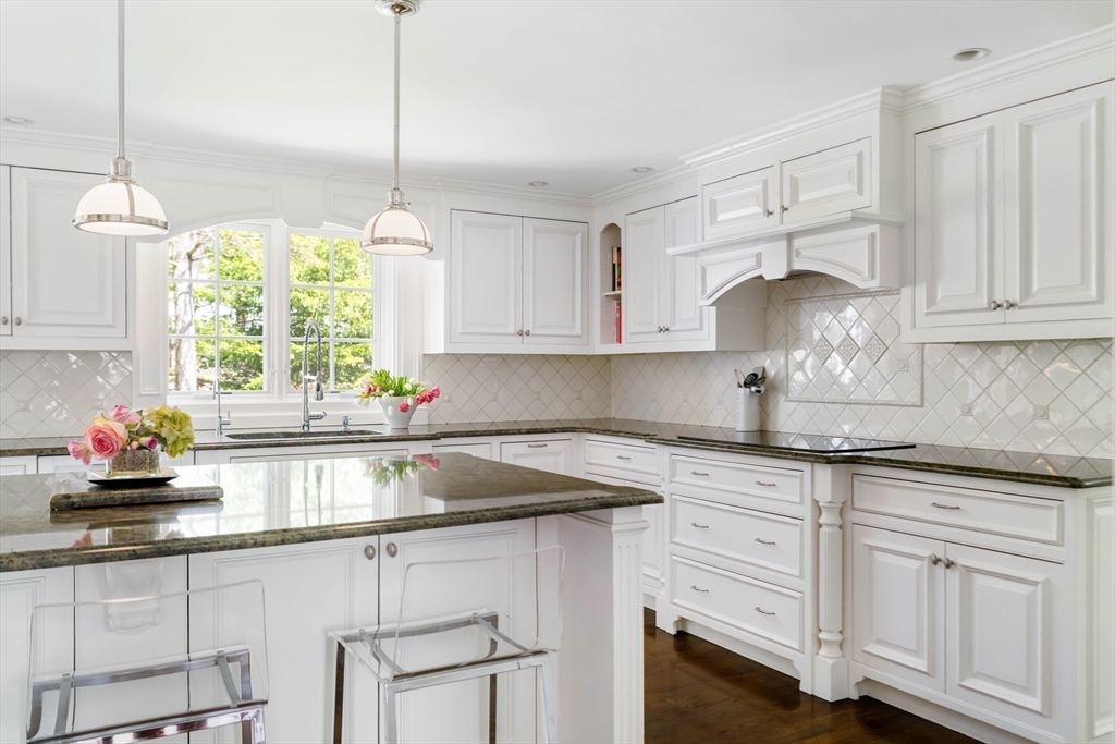 81 Hampshire Road Wellesley, MA 02481 - Photo 7 of 28 a kitchen with granite countertop white cabinets white appliances and a sink