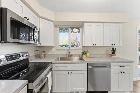 84 Fuller Street, Unit 1 Ludlow, MA 01056 - Photo 13 of 34 a kitchen with stainless steel appliances granite countertop a sink stove top oven and cabinets