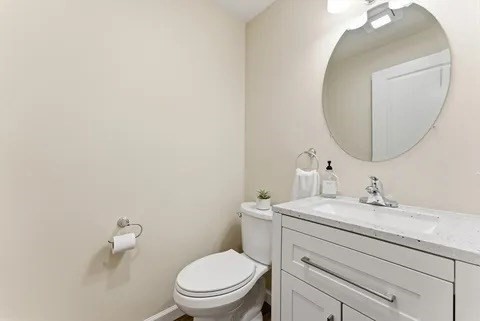 84 Fuller Street, Unit 1 Ludlow, MA 01056 - Photo 14 of 34 a bathroom with a toilet sink and mirror