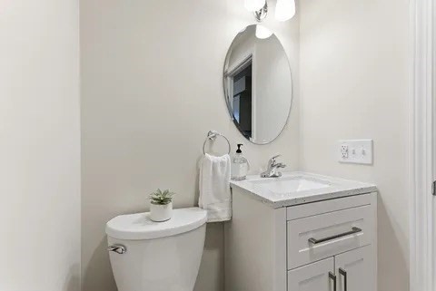 84 Fuller Street, Unit 1 Ludlow, MA 01056 - Photo 15 of 34 a bathroom with a sink toilet and a mirror