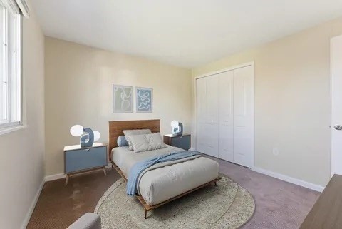 84 Fuller Street, Unit 1 Ludlow, MA 01056 - Photo 19 of 34 a bedroom with a bed and a painting on the wall