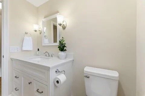 84 Fuller Street, Unit 1 Ludlow, MA 01056 - Photo 24 of 34 a bathroom with a sink a toilet and a mirror