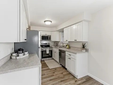84 Fuller Street, Unit 1 Ludlow, MA 01056 - Photo 10 of 34 a kitchen with a sink stove and cabinets