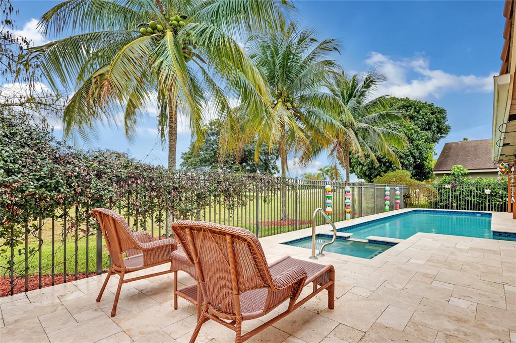 8324 Northwest 80th Street Tamarac, FL 33321 - Photo 34 of 40 a view of a chairs and table in patio with swimming pool