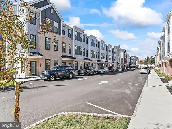 a city street lined with buildings and cars parked on the street