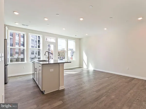 a room with wooden floors and white walls