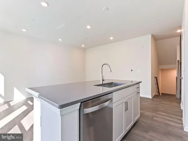 a kitchen with a sink and a refrigerator