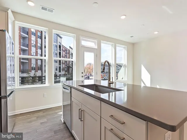 a kitchen with sink and large window