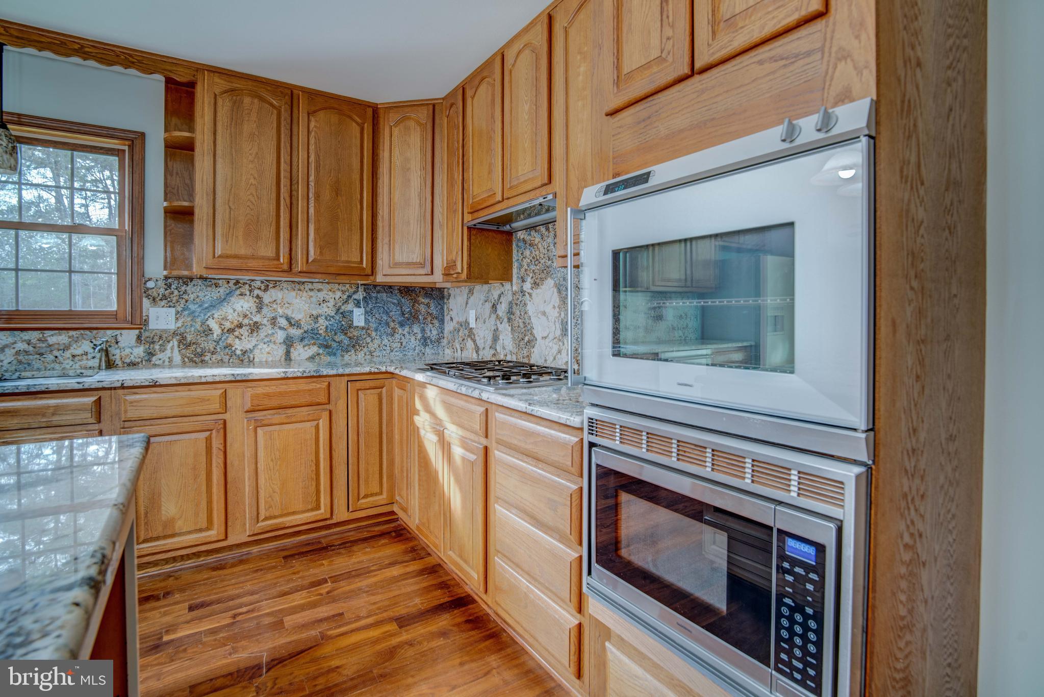 49530 Will's Road Dameron, MD 20628 - Photo 7 of 51 a kitchen with granite countertop cabinets stainless steel appliances and a counter space
