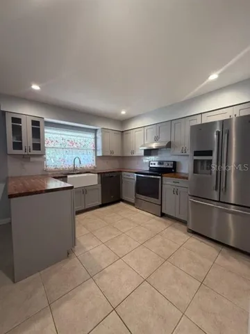 a kitchen with stainless steel appliances granite countertop a sink counter top space and cabinets