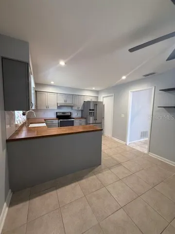 a kitchen with stainless steel appliances a stove and a refrigerator
