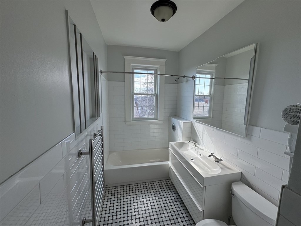 84 Tudor Street, Unit 6 Chelsea, MA 02150 - Photo 14 of 14 a bathroom with a sink a toilet and shower