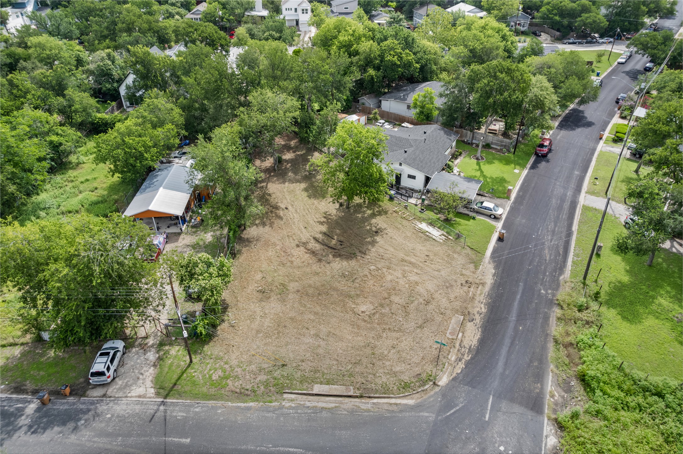 1201 Fort Branch Boulevard Austin, TX 78721 - Photo 16 of 19 An aerial view showcases a cleared lot ready for new construction within a verdant neighborhood.