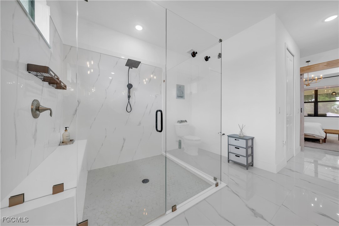 2609 27th Street West Lehigh Acres, FL 33971 - Photo 18 of 35 a bathroom with a bathtub and a shower