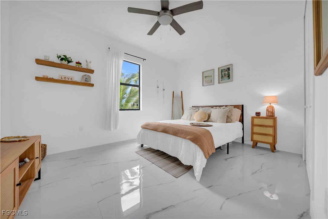 2609 27th Street West Lehigh Acres, FL 33971 - Photo 19 of 35 a bedroom with a bed and a window