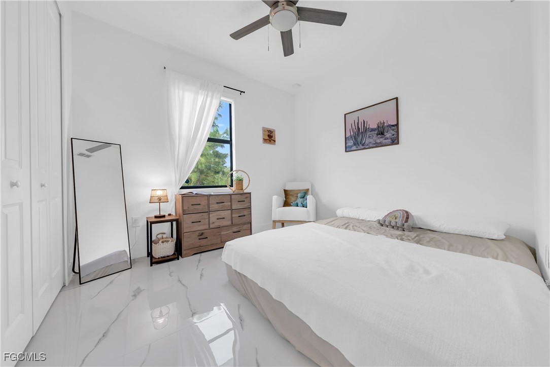 2609 27th Street West Lehigh Acres, FL 33971 - Photo 20 of 35 a bedroom with a bed dresser and a window