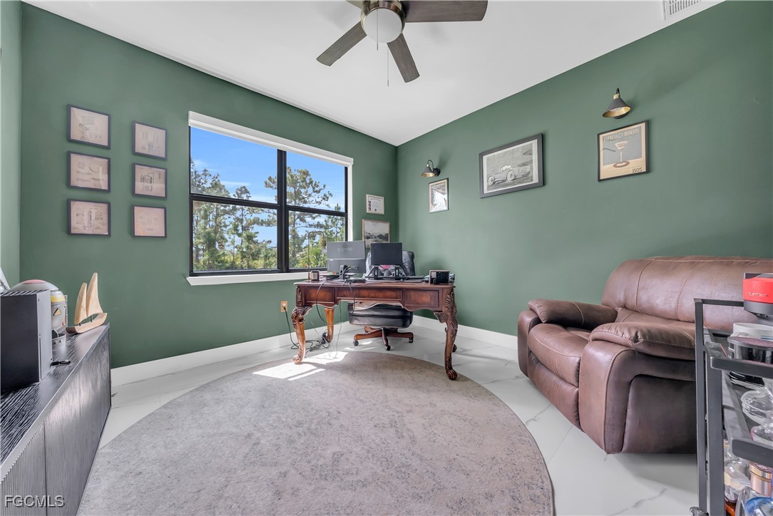 2609 27th Street West Lehigh Acres, FL 33971 - Photo 23 of 35 a living room with furniture and a window