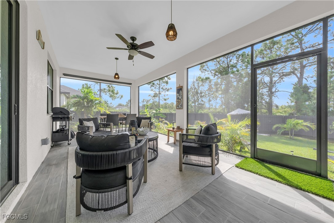 2609 27th Street West Lehigh Acres, FL 33971 - Photo 24 of 35 a living room with furniture and a floor to ceiling window