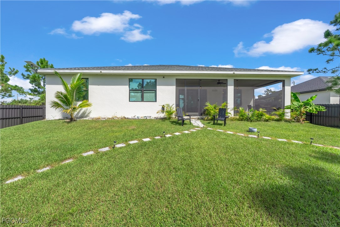 2609 27th Street West Lehigh Acres, FL 33971 - Photo 27 of 35 a view of a house with a backyard