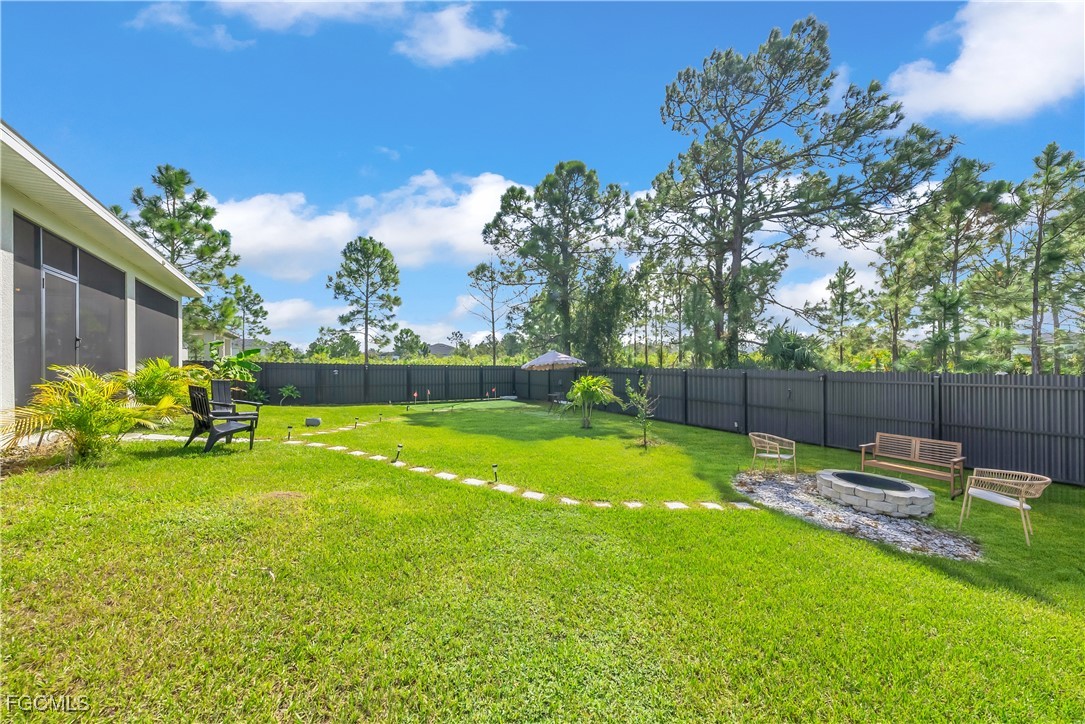 2609 27th Street West Lehigh Acres, FL 33971 - Photo 28 of 35 a view of a backyard with a table and chairs