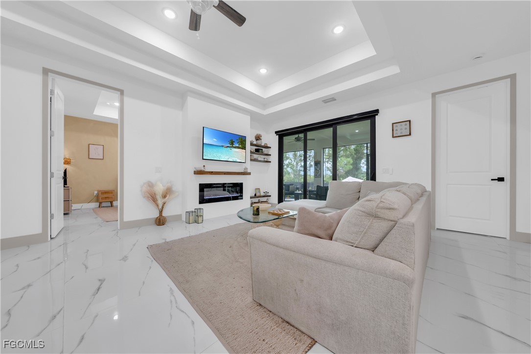 2609 27th Street West Lehigh Acres, FL 33971 - Photo 4 of 35 a living room with furniture a large window and a fireplace