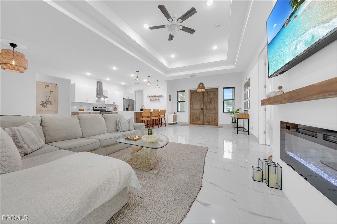2609 27th Street West Lehigh Acres, FL 33971 - Photo 5 of 35 a living room with furniture and a fireplace