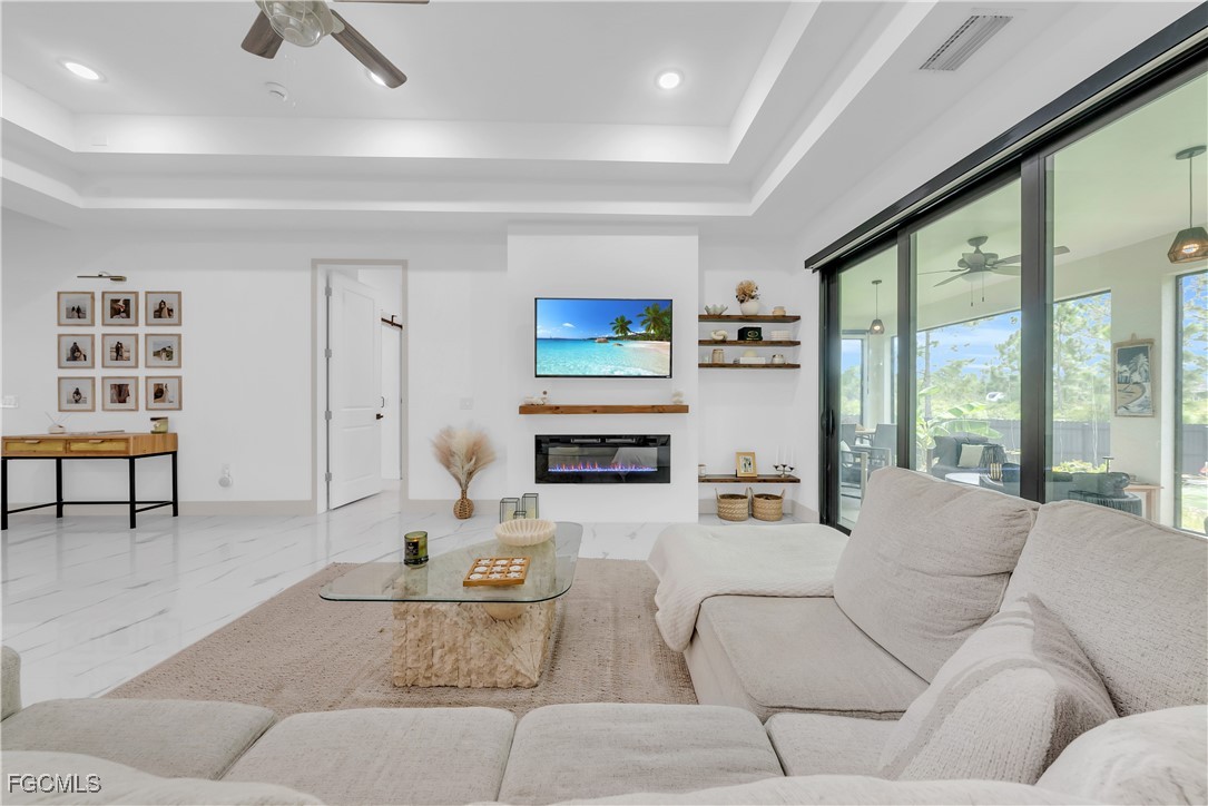 2609 27th Street West Lehigh Acres, FL 33971 - Photo 6 of 35 a living room with furniture and a flat screen tv