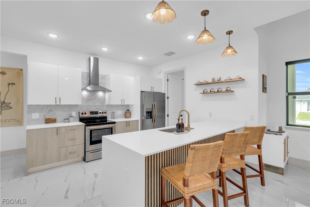 2609 27th Street West Lehigh Acres, FL 33971 - Photo 9 of 35 a kitchen that has a cabinets counter space and appliances