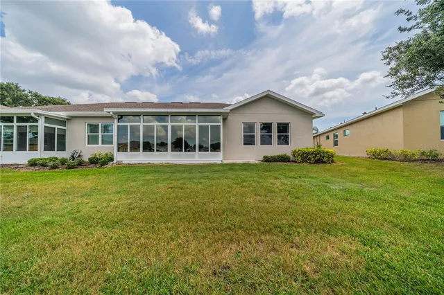 a view of a house with backyard and garden