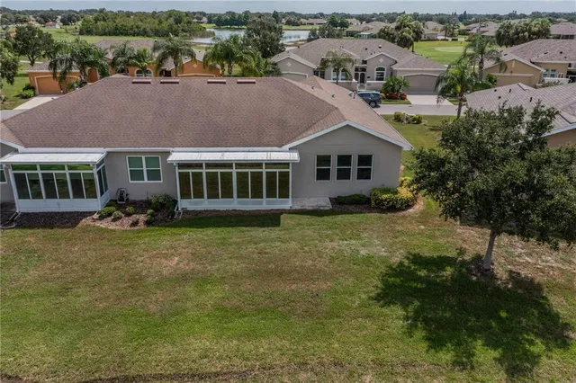 an aerial view of a house with garden space and lake view