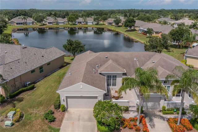 an aerial view of a house with a lake view