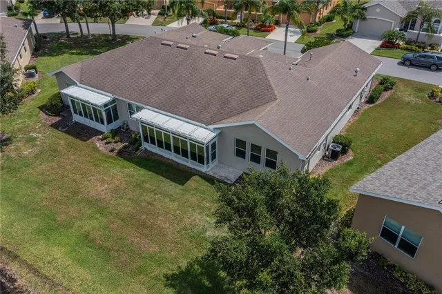 an aerial view of house with a yard