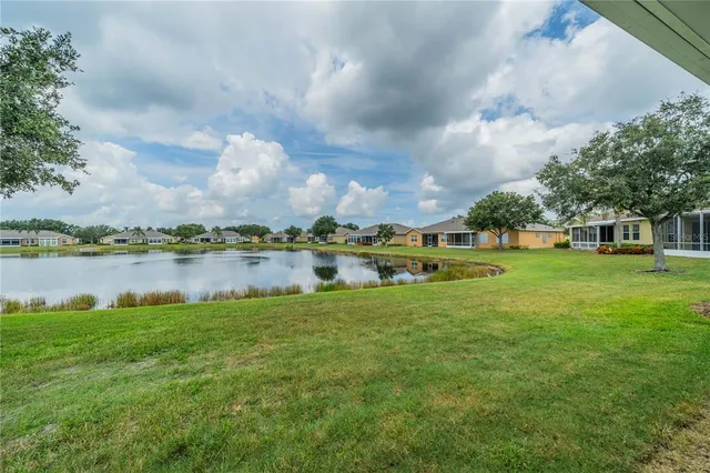 a front view of a house with a yard and potted plants