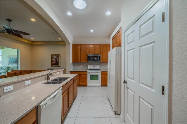 a kitchen with stainless steel appliances granite countertop a sink and cabinets