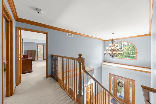 a view of a hallway to a livingroom with furniture