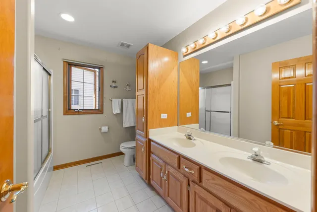 a spacious bathroom with a double vanity sink and a mirror