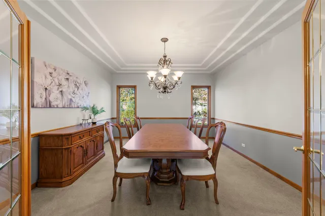 a view of a dining room with furniture and chandelier