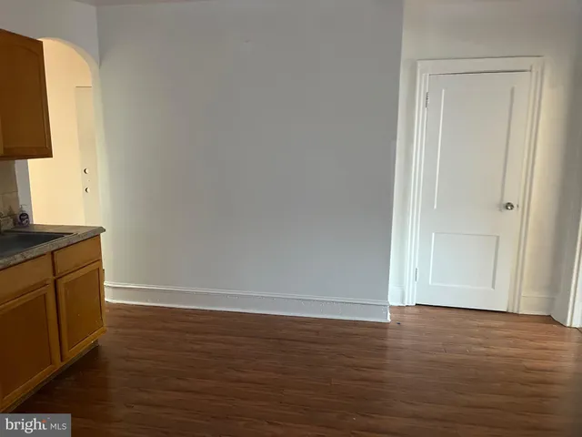 a view of room with window and wooden floor