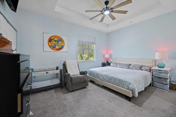 a bedroom with a bed and a chandelier