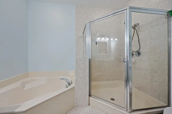 a bathroom with a glass shower door