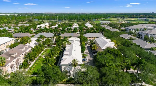 an aerial view of city lake and residential houses with outdoor space