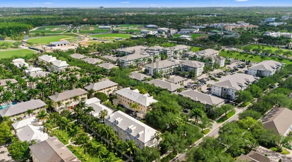 an aerial view of residential houses with outdoor space and river