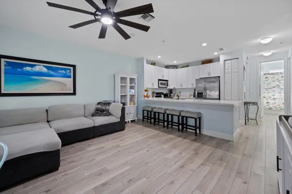 a living room with furniture and a wooden floor