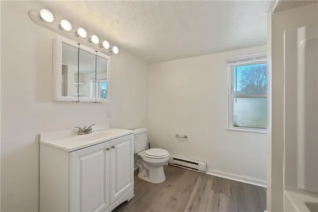a bathroom with a sink toilet and a mirror