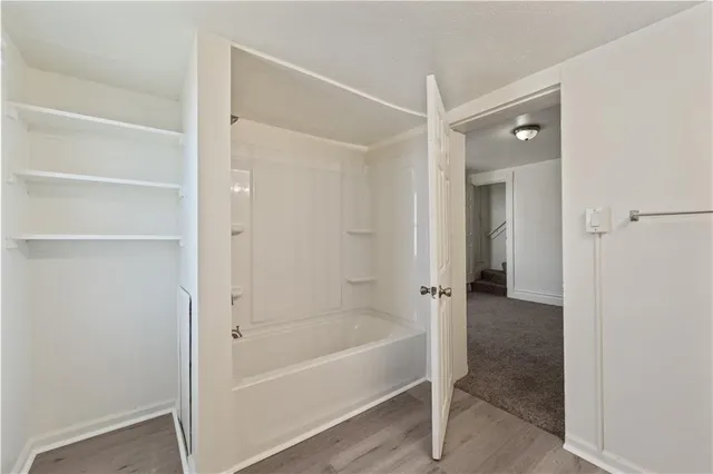 a bathroom with a bathtub and shower