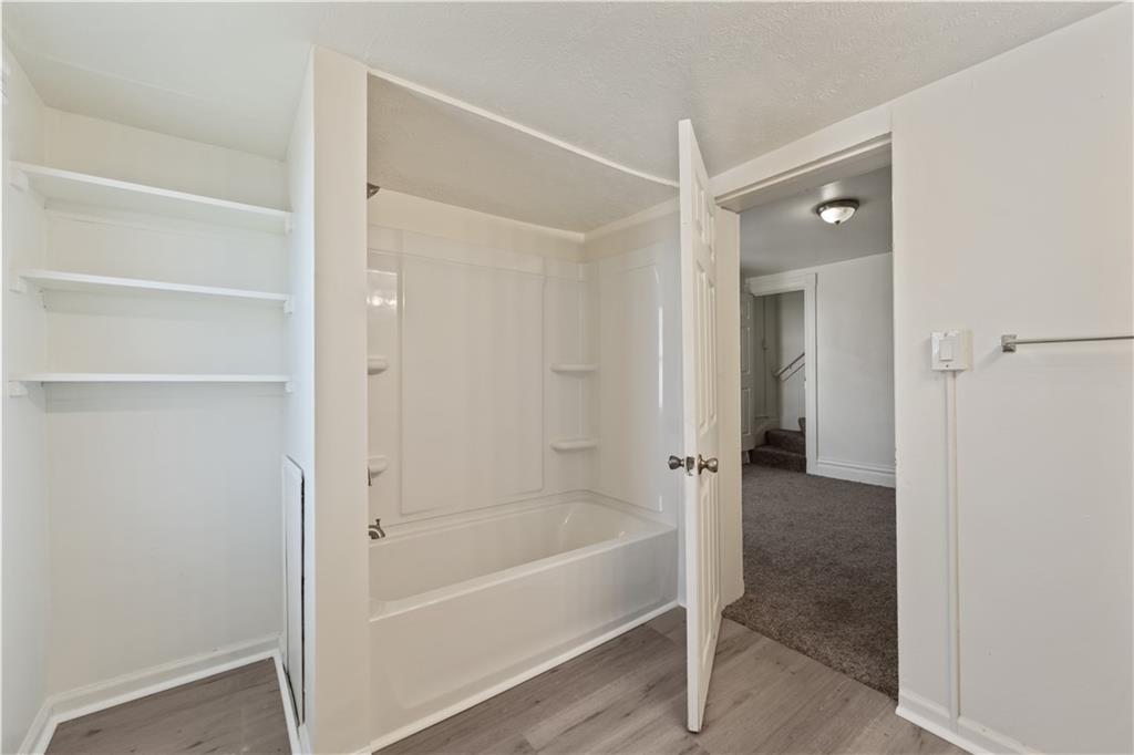 481 Union Street Verona, PA 15147 - Photo 15 of 25 a bathroom with a bathtub and shower